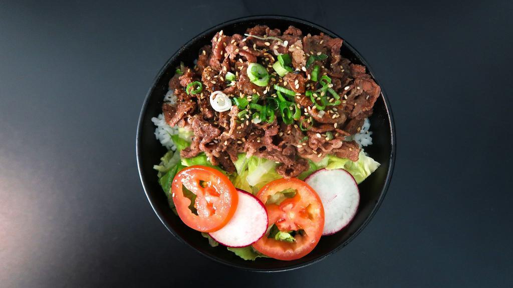 Beef Teriyaki · Beef teriyaki over rice with salad.