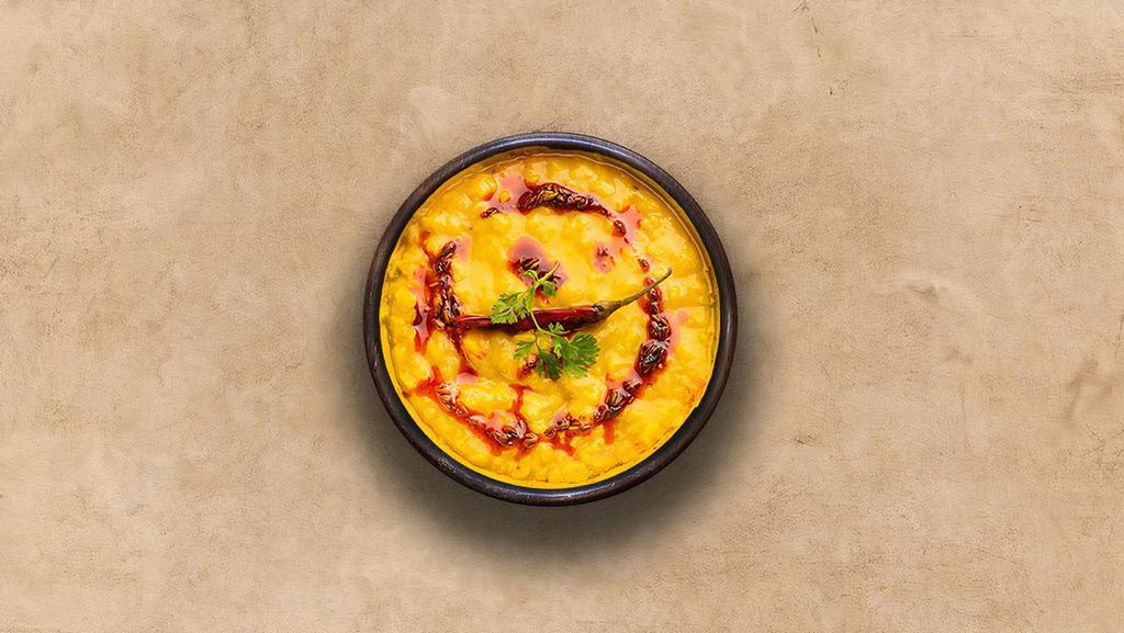 Yellow Lentils  · Slow-cooked lentils tempered with herbs and whole red chillies.