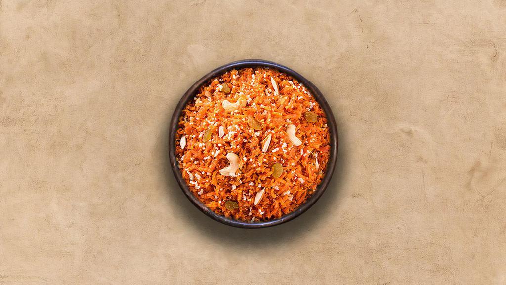 Carrot Halwa  · An Indian dessert made by simmering grated farm fresh carrots, whole milk and clarified butter.