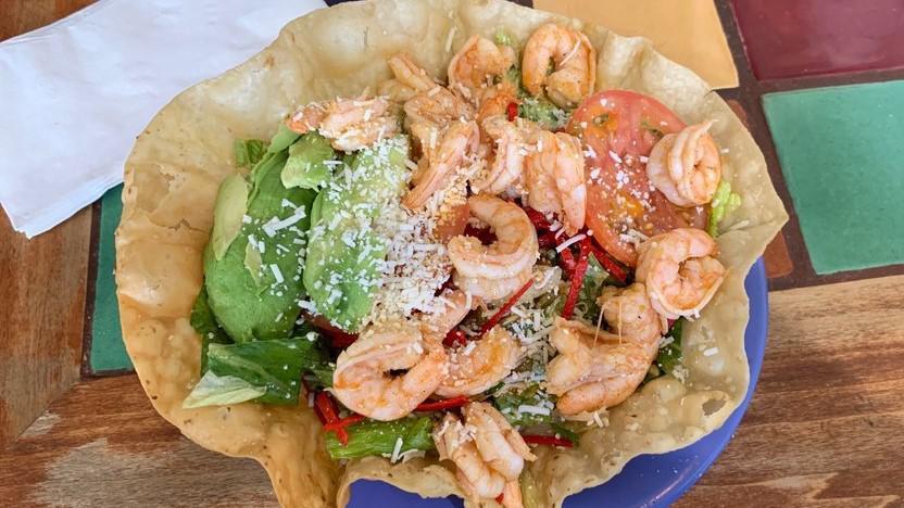 Shrimp And Avocado Salad · Grilled shrimp, romaine lettuce, tomatoes, cotija cheese, pepita seeds, tortilla strips and cilantro house dressing topped with avocado.