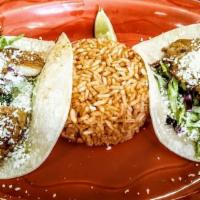 Two Grilled Fish Tacos · Grilled tilapia on corn tortillas, tartar sauce, topped with lettuce, cabbage, pico de gallo...
