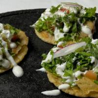 Sopes · Molded corn tortilla with refried beans, your choice of meat, onions, lettuce, diced tomato,...