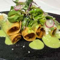 Flautas De Pollo · Deep-fried homemade tortillas rolled with chicken, topped with guacamole sauce, lettuce, tom...