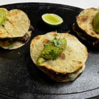 Mulitas · Your choice of meat, mozzarella cheese, onion, cilantro, and guacamole on corn tortillas.