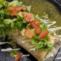 Wet Burrito · Has rice, beans, cheese, tomato, cilantro & onions inside. Marinated with salsa verde & Amer...