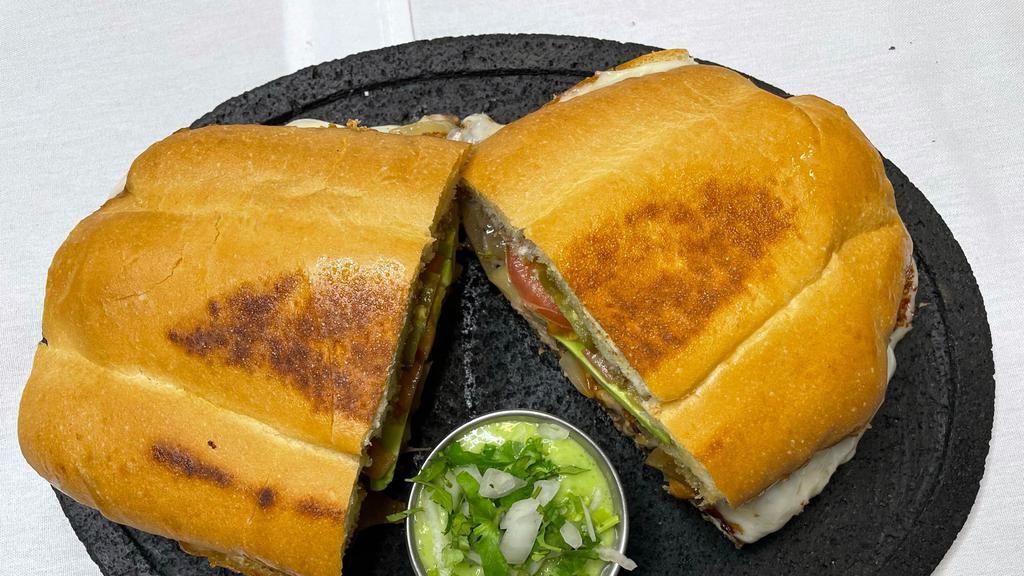 Torta Hawaiina · French bread with beans, ham, pineapple, milk cheese, avocado, onions, chipotle sauce, and mayonnaise