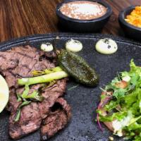 Carne Asada · Grilled steak served with a mix of shredded lettuce, sliced tomato, avocado, grilled onions,...