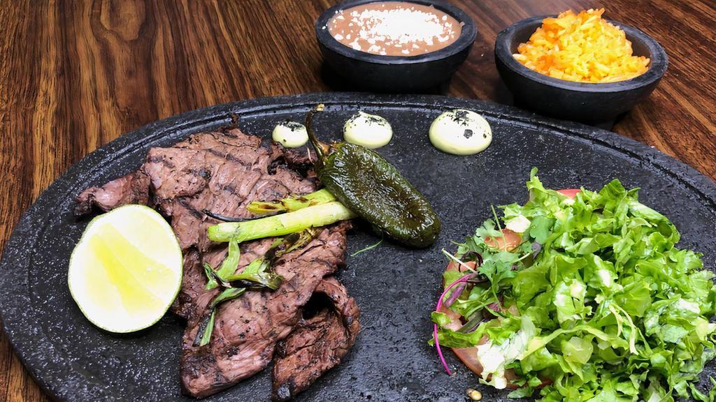 Carne Asada · Grilled steak served with a mix of shredded lettuce, sliced tomato, avocado, grilled onions, fried jalapeño, and your choice of flour or corn tortillas