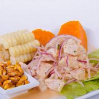 Ceviche De Pescado · Premium sea bass fish marinated in lime juice. Served with corn, yams, and fried corn.
