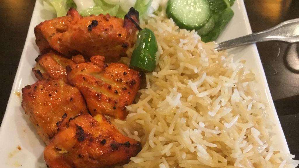 Chicken Kabob · Two skewers of tender chunks of chicken breast, marinated in special herbs, spices and broiled over the grill (kababs are served with a side of bread or basmati rice or salad).