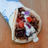 Beef Gyro Wrap · Slices of beef wrapped in pita bread with tomatoes, red onions, garlic sauce and tzatziki sa...