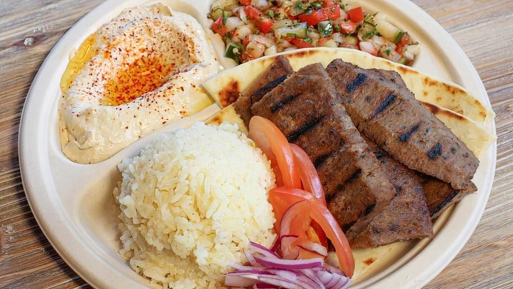 Beef & Lamb Gyro Plate · Our most popular plate. Sliced gyro with tzatziki sauce. Served with hummus, Israeli salad, rice, and pita.