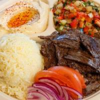Beef Shawerma Plate · Beef sliced from a vertical spit with tahini sauce or tzatziki sauce. Served with hummus, Is...