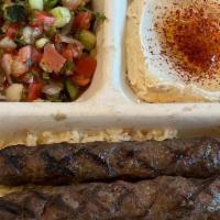 Kofta Plate (Ground Beef) · Two premium ground beef kebabs. Served with hummus, Israeli salad, rice, and pita.