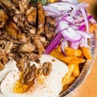 Loaded Beef Shawerma Fries · Topped with beef shawerma slices, fresh tabbouleh, hummus, tomatoes, and red onions. Seasone...
