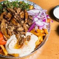 Loaded Chicken Shawerma Fries · Topped with chicken shawerma slices, fresh tabbouleh, hummus, tomatoes, and red onions. Seas...