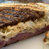 Classic Reuben · Corned beef, melted swiss, sauerkraut with 1000 Island dressing on marble rye.  Served with ...