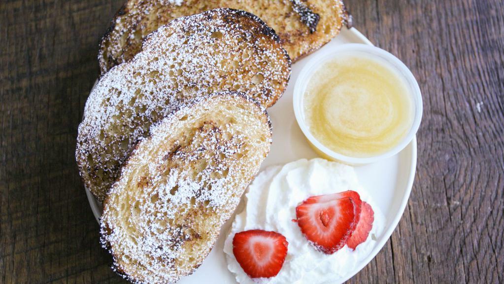 French Toast · 2 slices of French toast with butter, powdered sugar, fruit, whip cream and old fashioned buttermilk syrup.