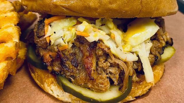 Lunch Pulled Pork · Toasted brioche bun, incredible smoked sauced and seasoned pulled pork shoulder, Tangy Vinegar and Carolina Gold sauces, Jalapeño-IPA pickles, topped with our house vinegar Cole Slaw. Add a small side or soft drink for an additional charge.