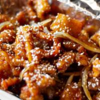 Sesame Chicken · Crispy panko-coated chicken slices seared with onions, glazed with our caramelized sesame sa...