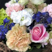 Sing It Spring · This joyful arrangement includes hot pink roses, pink roses, green hydrangea, and Spring hya...
