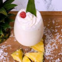 Caribbean Dream (Pina Colada) · creamy coconut and pinnaple drink topped with whipped cream and a cherry