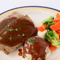 Meatloaf Dinner · Homemade meatloaf dinner with mashed potatoes or French fries, topped with grilled onions an...