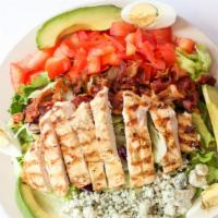 Cobb Salad · Mixed greens topped with sliced grilled chicken strips, crumbled blue cheese, bacon, tomatoe...