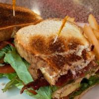 California Blt (Triple Decker) · Crispy bacon, lettuce, tomato slices, avocado and mayonnaise on a toasted white bread.