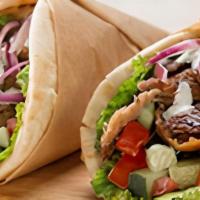 Traditional Gyro · Garbanzo Way includes: romaine lettuce, gyro meat, tzatziki sauce, sliced tomatoes, pickled ...