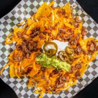 Nachos · Nacho chips, Jack and Cheddar cheese, guacamole, cheese sauce, jalapeños and choice of meat.