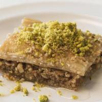 Baklava · Thin layers of phyllo pastry dough with a crushed walnut filling baked and drizzled with sug...