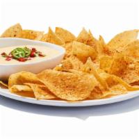 Chips & Queso · It ain’t rocket surgery. It’s a creamy blend of melted cheeses mixed with roasted red and gr...