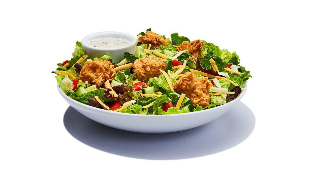 Garden Salad · Spring mix greens piled with diced tomatoes, crips cucumbers, cheddar cheese, Monterey Jack cheese and croutons and your choice of salad dressing.