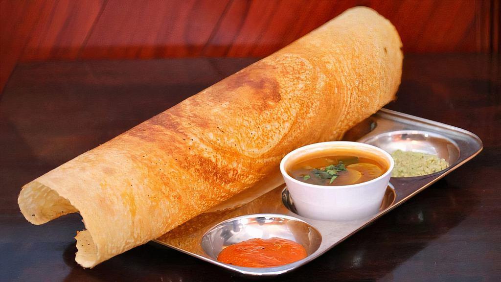 Dosa (1 Pc) · Dosa is a savoury thin crispy crepe made from urad dhal flour and rice flour with fenugreek. Served with lentil soup (Sambar), fresh Coconut chutney, fresh Tomato chutney