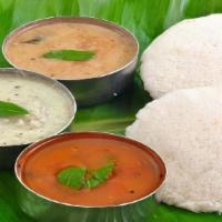 Idli (2 Pcs) · Steamed lentil and rice flour cake served with lentil soup (Sambar), fresh Coconut chutney &...