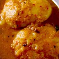 Sambar Idli (2 Pcs) · Soft and Fluffy Idli dipped in lentil soup (Sambar), topped with Ghee, cilantro and onion