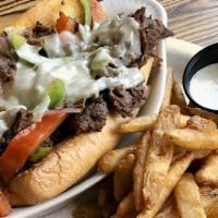 Philly Cheesesteak · Slow roasted top sirloin, sliced thin and layered with caramelized onions, red and green bel...