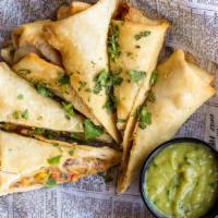 Southwest Egg Rolls · Egg rolls packed with chicken, cilantro, black bean, onion and southwestern spices. Served w...