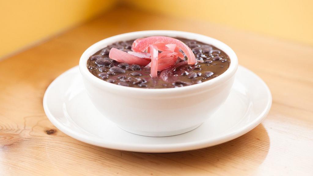 Frijoles Negros · Black beans, epazote, pickled onions.