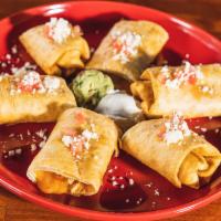 Chicken Taquitos · Two rolled flour tortillas stuffed with chicken and mozzarella cheese, served crispy, garnis...