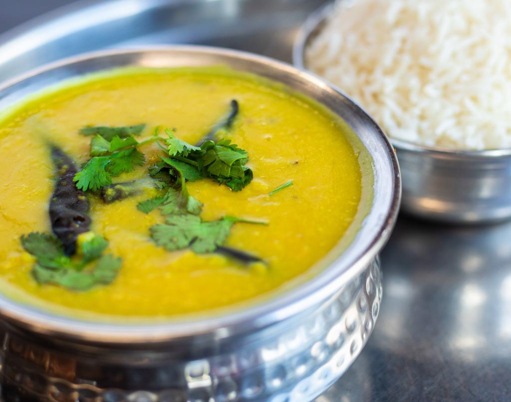 Tarka Dal (Vegan) · Mixed of four types of yellow lentils and beans sautéed with garlic, onions, ginger, and tomatoes.