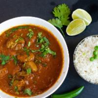 Goat Curry (Mutton Curry) · Slow cooked traditional bone-in meat with onions, tomatoes, ginger, garlic and aromatic spic...