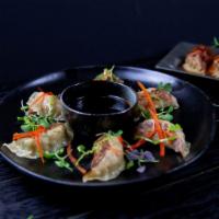 Chicken Gyoza · With chili garlic sauce (steamed or pan fried).