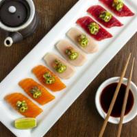 Trio Of Sashimi* · Tuna, salmon, and yellowtail sashimi with wasabi salsa.