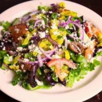 Greek Salad · Spring mix, kalamata olives, cucumber, tomato, red onion, pepperoncini and feta dressing in ...