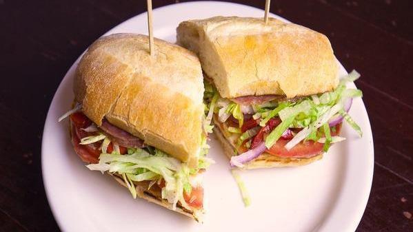 Italian Meat Sandwich · Salami toscana, finocchiona, mortadella, mama lil's peppers, lettuce, tomato, red onion, provolone and Italian dressing. Served on a freshly baked 8