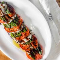 Caprese Salad · With sliced tomatoes, fresh basil leaves, fresh mozzarella served with balsamic vinaigrette ...