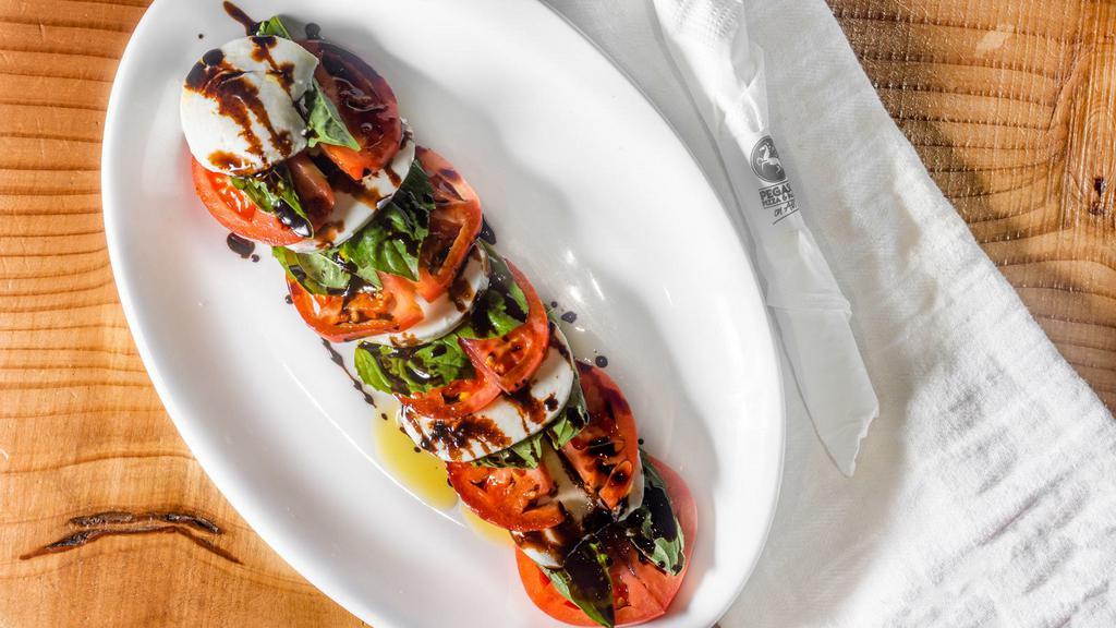 Caprese Salad · With sliced tomatoes, fresh basil leaves, fresh mozzarella served with balsamic vinaigrette dressing.