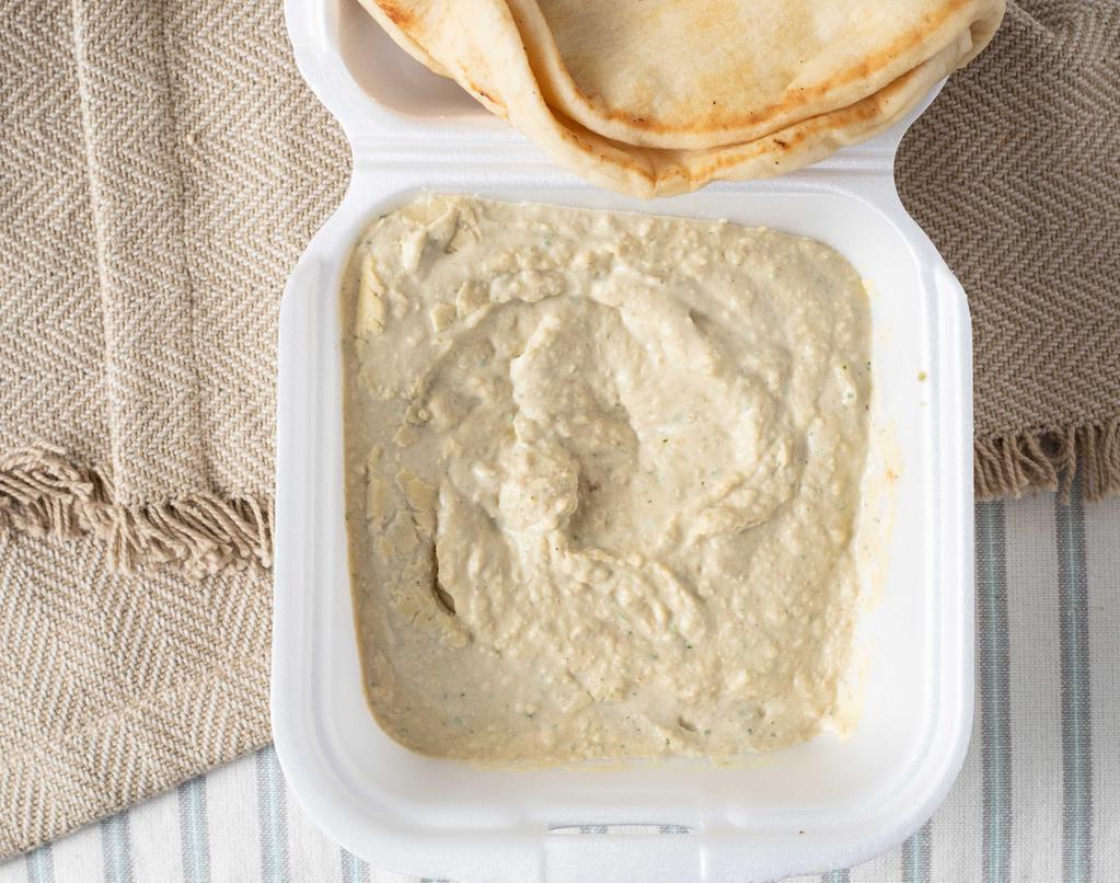 Hummus · Vegetarian. House blended chickpeas, tahini, and olive oil with fresh garlic and lemon juice. Served as a dip with two pita breads.